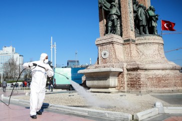 ISTANBUL, TURKEY - MARCH 12: A member of health official, wearing a protective suit, disinfects Taksim Square and Istiklal Street as a precaution to Coronavirus (Covid-19) in Istanbul, Turkey on March 12, 2020. (Photo by Ahmet Bolat/Anadolu Agency via Getty Images)