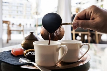 Turkish Coffee is pouring in coffee cup
